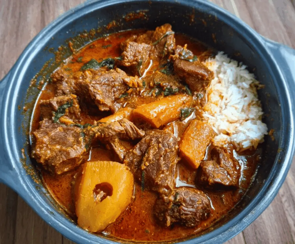 Hearty African Beef Stew with tender beef, fresh vegetables, and rich spices in a rustic bowl.