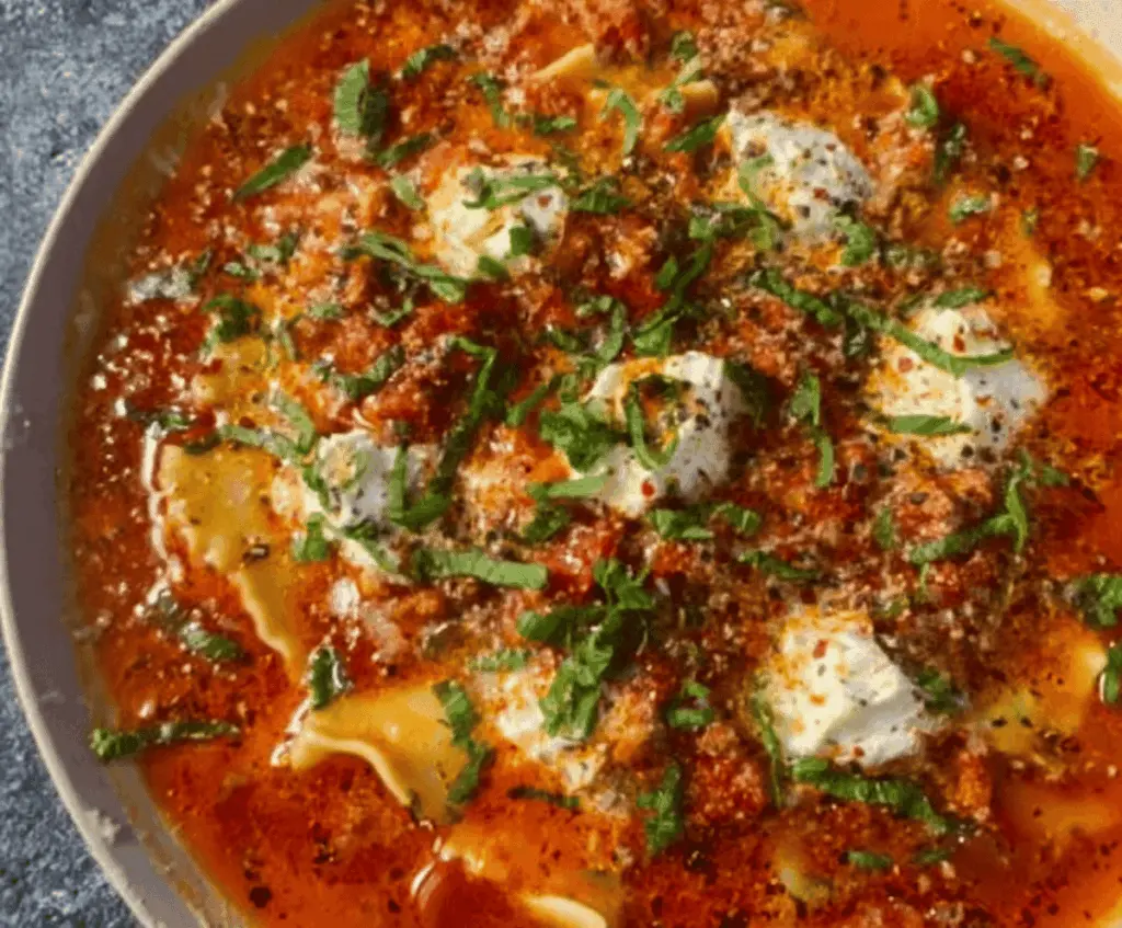Delicious high-protein lasagna soup with layers of melted cheese, savory ground meat, and hearty vegetables in a flavorful tomato broth