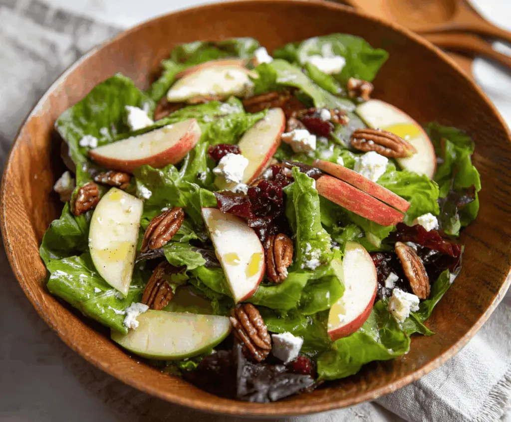 Fresh TikTok Apple Goat Cheese Pecan Salad featuring sliced apples, creamy goat cheese, crunchy pecans, and mixed greens for a delicious, healthy appetizer or side dish.