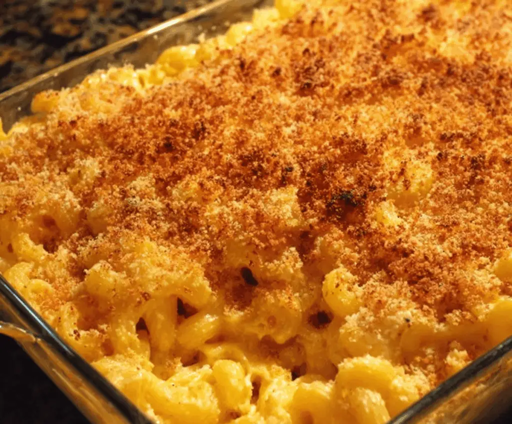 Creamy baked mac and cheese casserole topped with golden breadcrumbs, perfect for serving a crowd