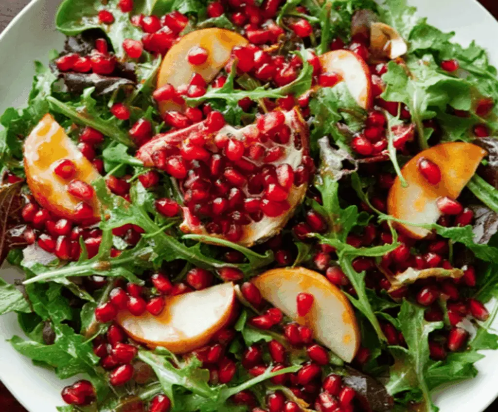Fresh pomegranate salad topped with a tangy cider dressing, vibrant and healthy for a nutritious meal.