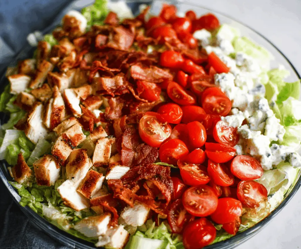Delicious Ultimate BLT Chicken Salad with crispy bacon, fresh lettuce, ripe tomatoes, and tender grilled chicken in a vibrant bowl.